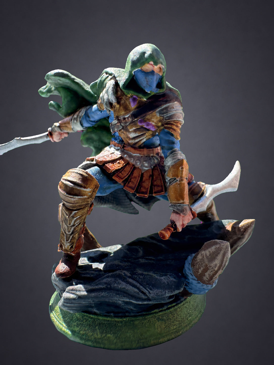 Serran painted assassin green cloak - lunging pose with twin curved blades on rocky base